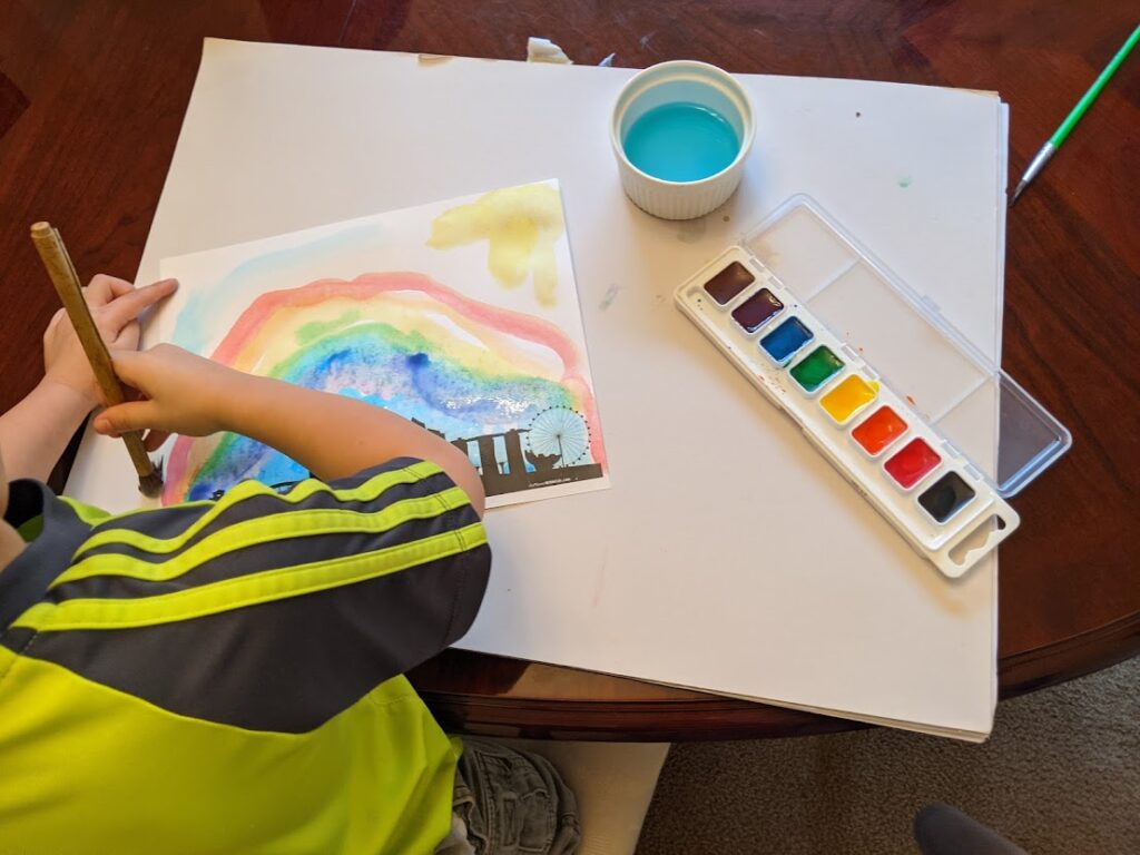 Child painting a rainbow