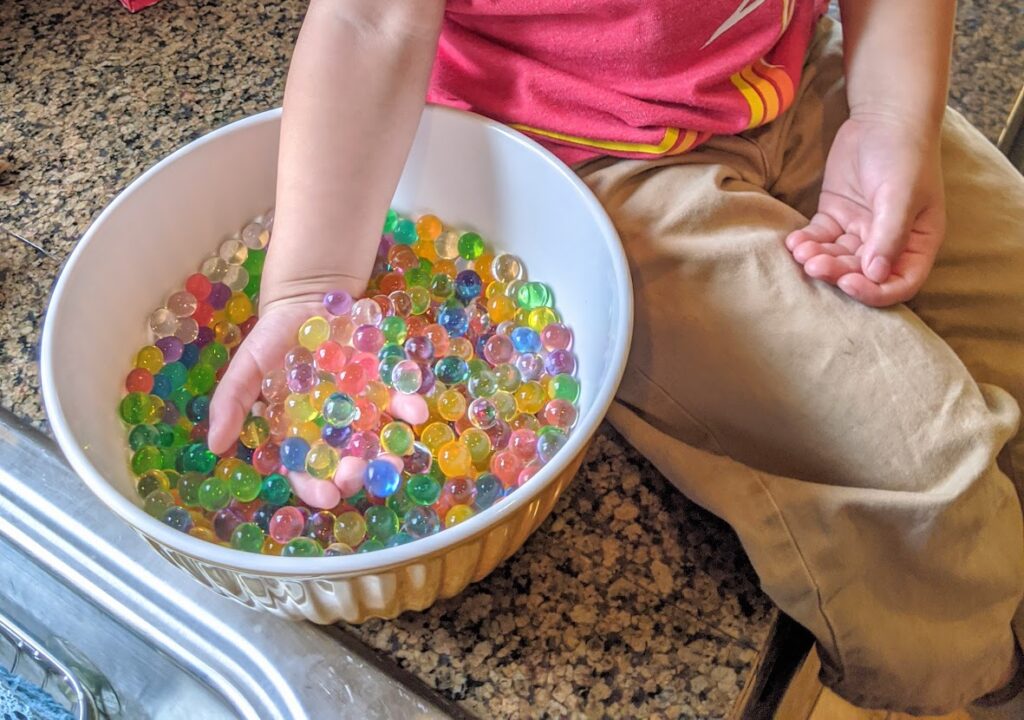 Child holding water beads