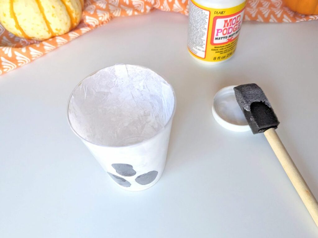Finish putting the tissue paper inside the cup to complete the ghost craft