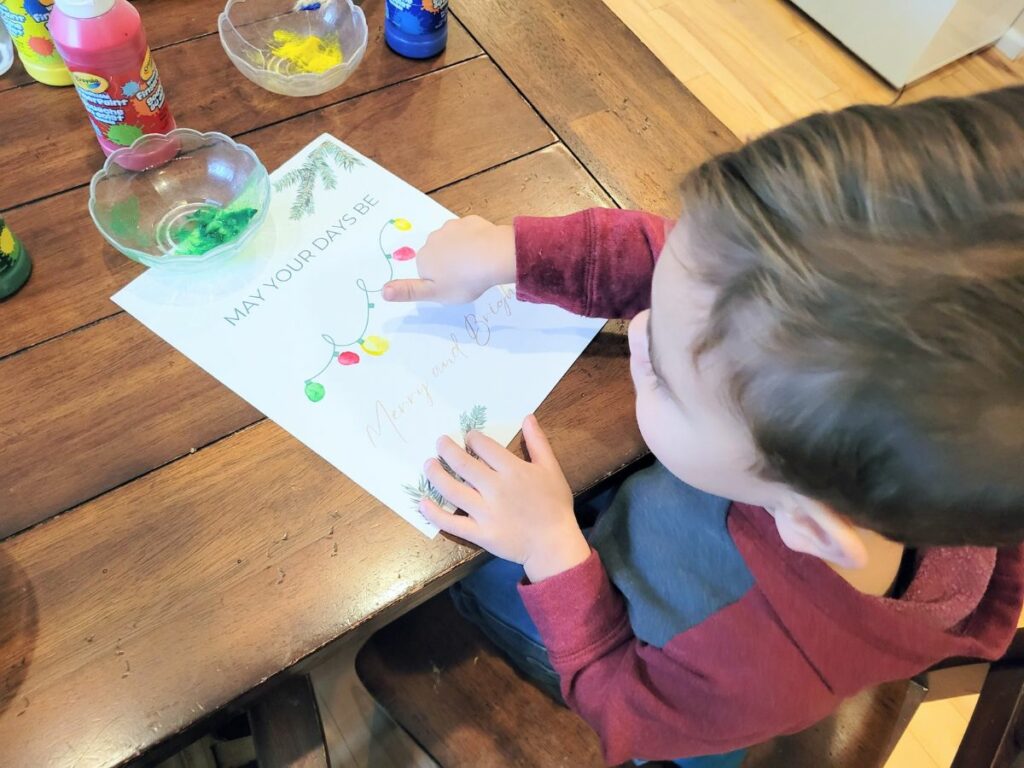 Child making Christmas handprint art