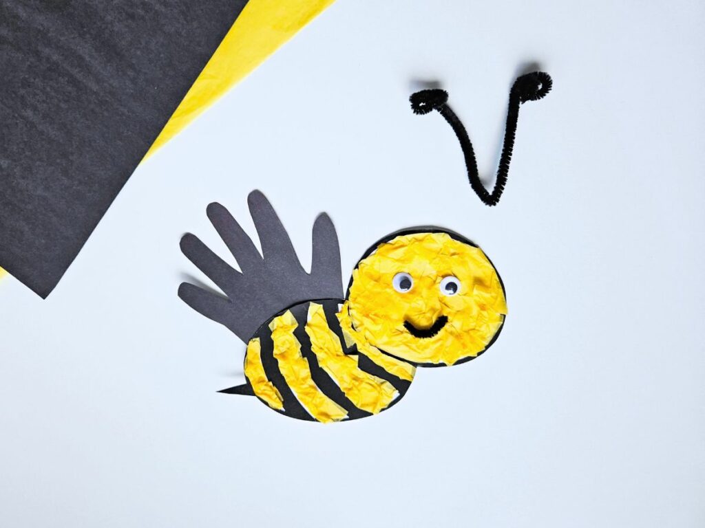 Bee antennae made out of pipe cleaner next to bee craft