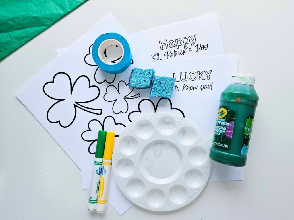 Materials to make a sponge painting shamrock craft for kids