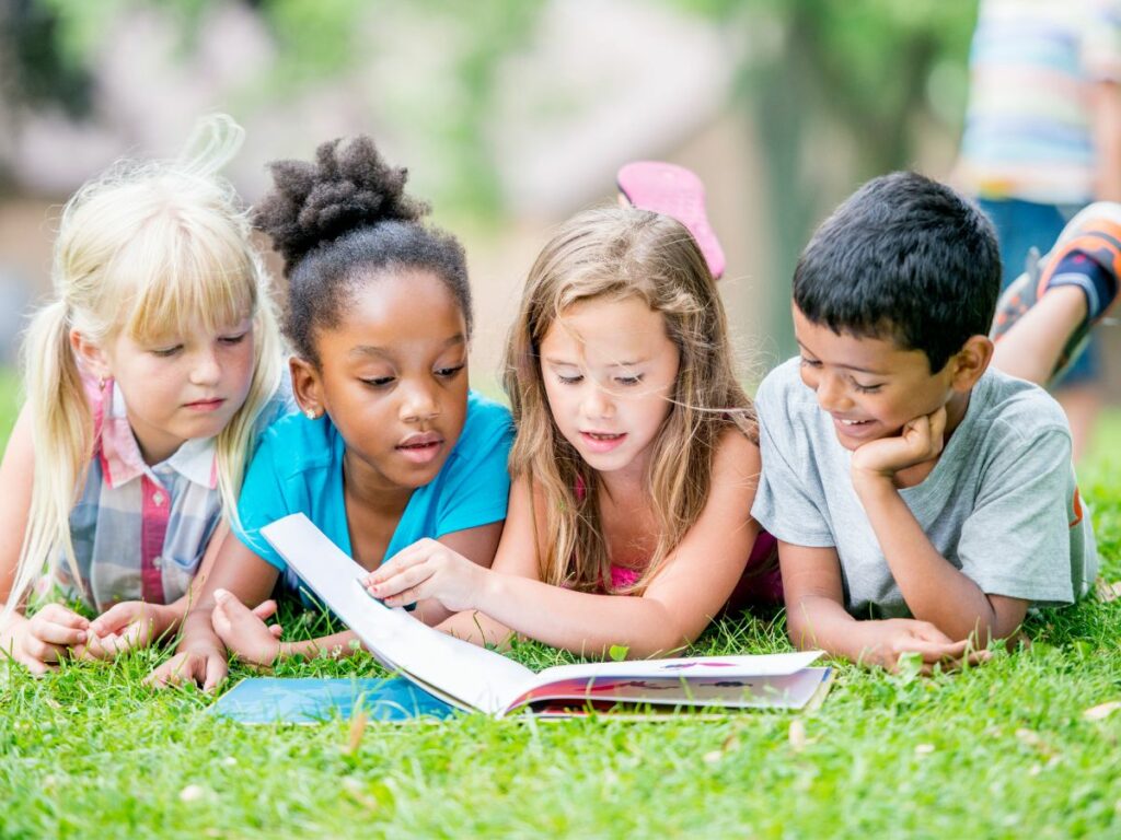 Kids reading outside in the summer