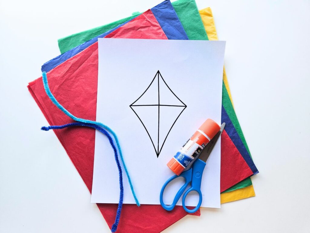 Materials to make a tissue paper kite craft